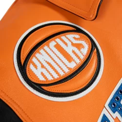 Pelle Leather Jacket Orange body with black leather sleeves and NY Knicks Logos in Blue, Orange & Black Available at Brick City Leather